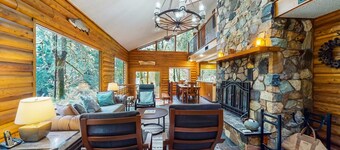 Spacious riverfront lodge with beach access, private hot tub & forest views