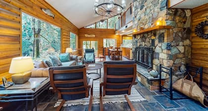 Spacious riverfront lodge with beach access, private hot tub & forest views