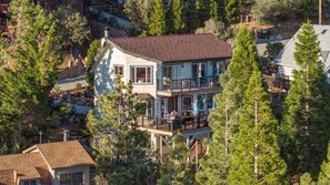 A two-story house with a balcony, surrounded by trees. - Big Bear Cabin w/ Hot Tub, Views, Deck & Firepit (Big Bear Lake)