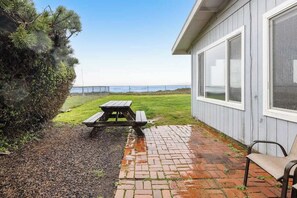 Outdoor dining - Vintage home with ocean views, private path to shore & fenced dog-friendly yard (Waldport)