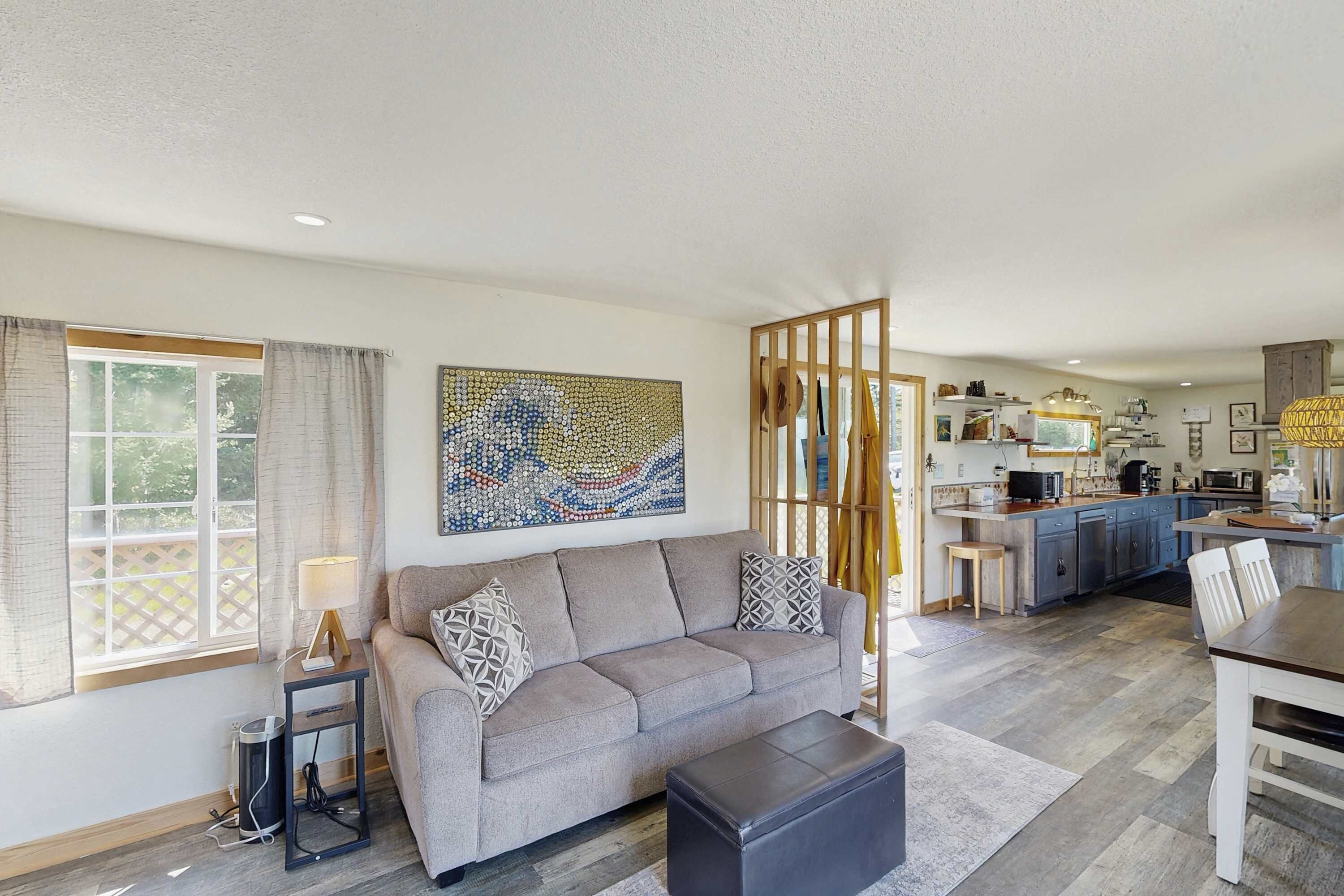 A modern living room with a sofa, a coffee table, and a dining table.