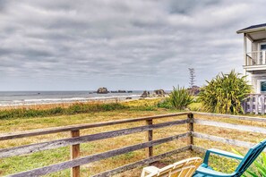 A wooden deck with a view of the ocean and rocky formations. - Dog-friendly oceanfront home on a bluff with spectacular views (Bandon)
