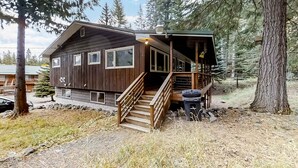 A wooden cabin with a staircase, surrounded by trees. - Large Dog-Friendly Duplex with Lovely Interior + Free WiFi, Private Washer/Dryer (Joseph)
