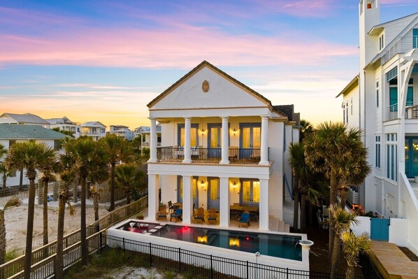 A two-story building with a balcony, a pool, and palm trees. - Seagrove "Belle Plage" 517 Eastern Lake Rd (Santa Rosa Beach)