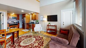 A compact living space with a dining area, kitchen, and seating area.