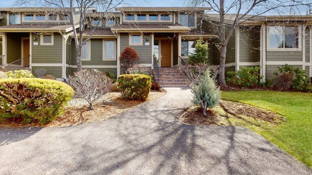 A two-story house with a front porch, a driveway, and a well-maintained lawn. - Spacious townhouse with fireplace, fast WiFi & resort pools-hot tub-golf (Eagle Crest)