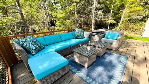 A deck with a sofa, two chairs, a table, and a rug. - Brand-new home with hot tub, deck, fast WiFi, central AC, & great location (Manzanita)