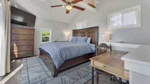 A bedroom with a bed, dresser, nightstands, and a ceiling fan. - Newly Remodeled Ocean View Retreat, Balcony and BBQ (Port Orford)