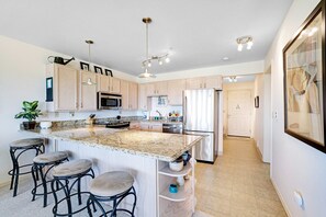 Fridge, microwave, oven, stovetop - Sunny & stylish oceanfront condo with WiFi, washer/dryer & private balcony (Long Beach)
