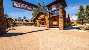 A rustic building with a sign reading 'The Village at Sunriver.' - Golf Course Views, Half Mile to the Village - Includes SHARC Access (Sunriver)