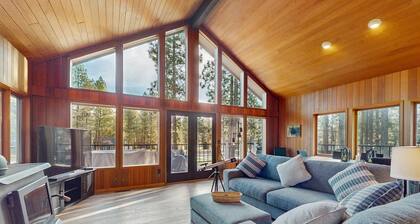Whimsical tree-lined stay with wood stove, AC, shared amenities, and large deck