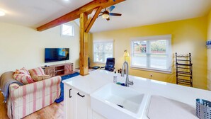 A kitchen with a white countertop, a sink, and a ceiling fan. - Seaside cottage with deck, washer&dryer, full kitchen, & great location (Newport)
