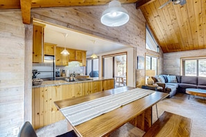 A wooden interior with a dining area, kitchen, and seating space. - Central Oregon cabin with SHARC amenities, fireplace, & grill - near skiing (Sunriver)