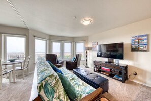 Living area - Dog-friendly oceanfront condo with electric fireplace - walk to the beach (Long Beach)