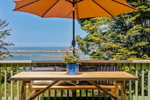 Outdoor dining - Charming coastal home with water views, large covered deck (Gold Beach)