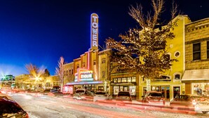 A street scene with a building featuring a neon sign that reads 'TOWER.' - Adorable Bend townhome with ideal location, kitchenette & central AC (Bend)