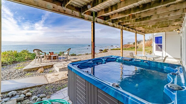 A hot tub under a wooden pergola with a view of the ocean. - Gorgeous oceanfront estate with amazing views & hot tub - steps to quiet beach (Brookings)