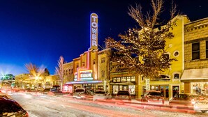 A street scene with a building featuring a neon sign that reads 'TOWER.' - Spacious Home - Golf Course Views, Central AC, WiFi & Alfresco Living (Bend)