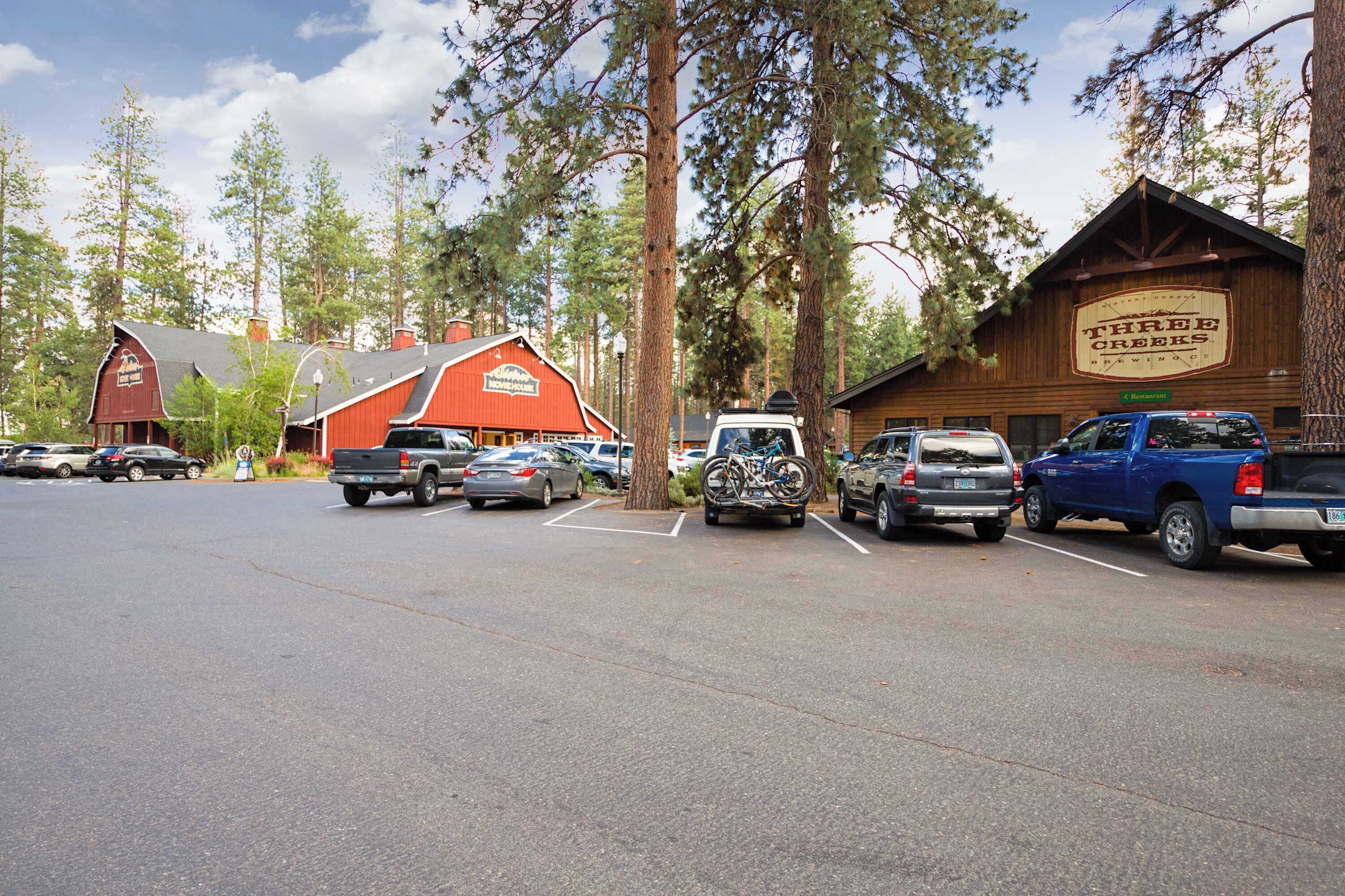 A parking lot with several cars and a building labeled 'Three Creeks.'