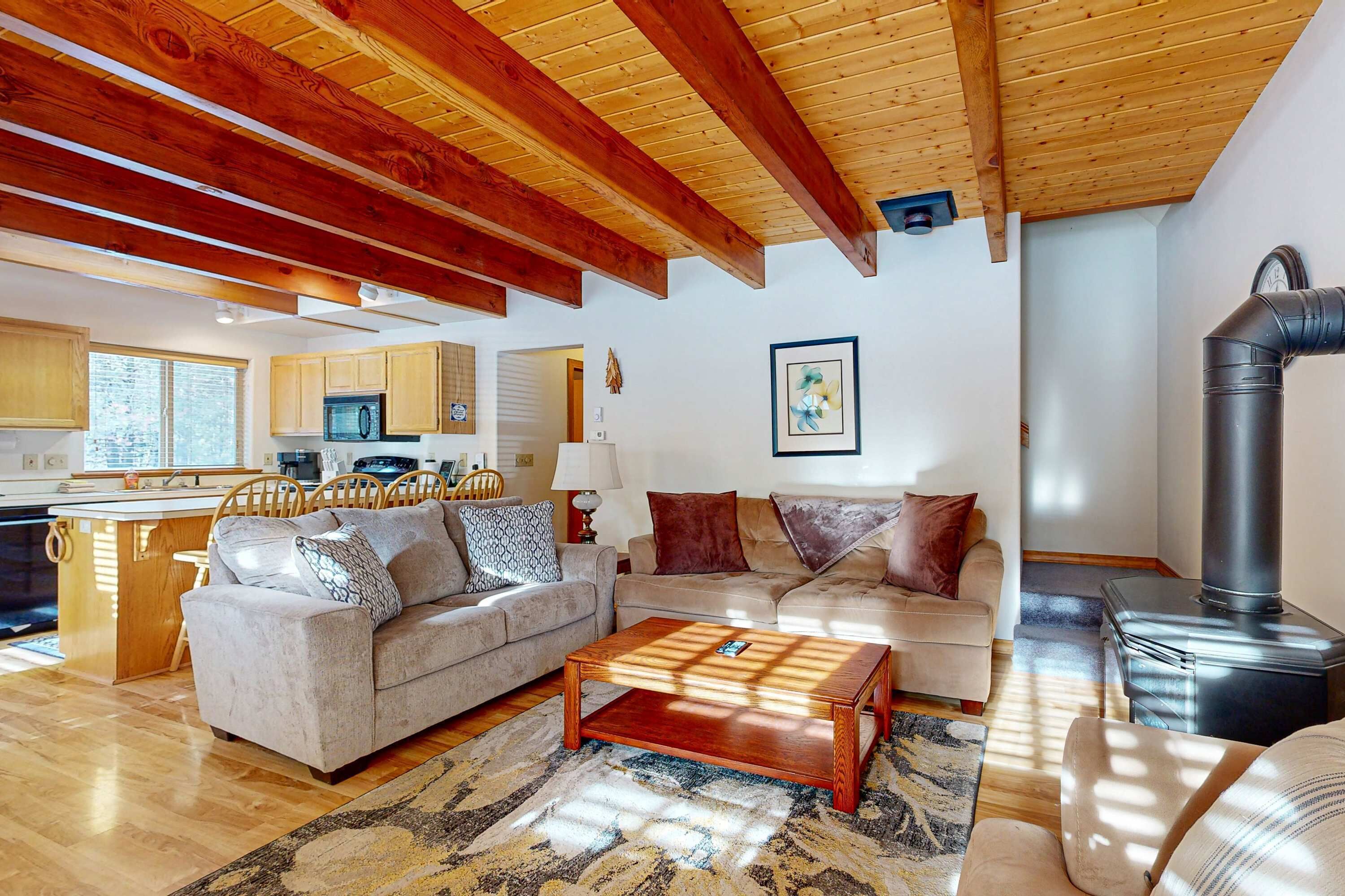 A living room with a sofa, coffee table, and a fireplace.