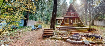 Dog-friendly A-frame near the river with game room, firepit, wood stove, & grill
