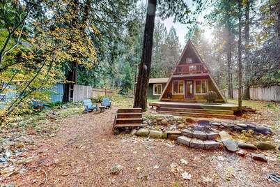 Dog-friendly A-frame near the river with game room, firepit, wood stove, & grill