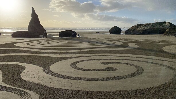 A beach with large rocks and spiral patterns on the sand. - Charming dog-friendly home with ocean-view, beach access, & washer/dryer (Bandon)