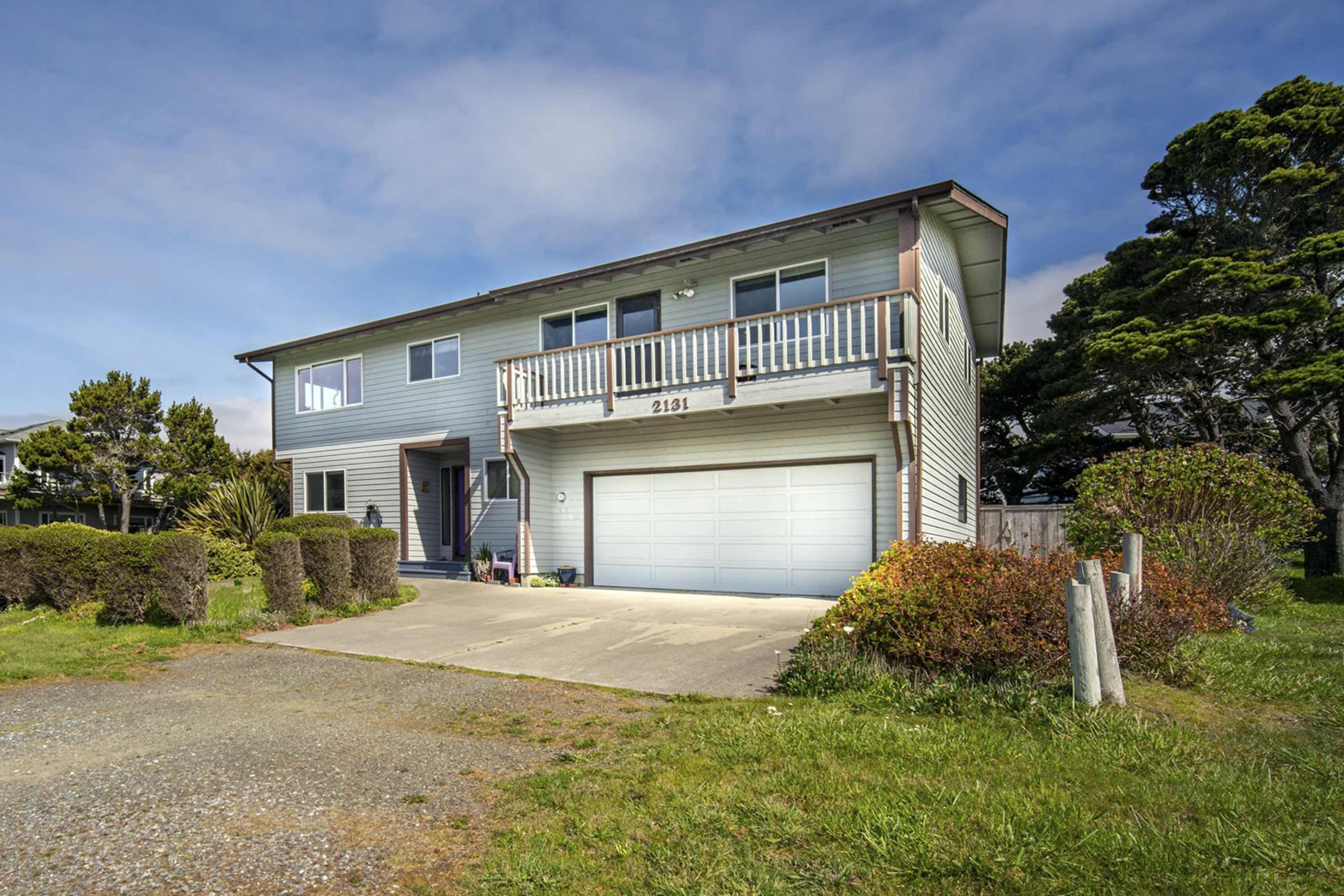 A two-story house with a garage, a balcony, and a number 2131.