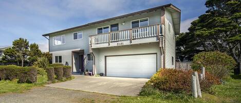 A two-story house with a garage, a balcony, and a number 2131.