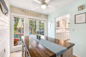 A kitchen with a wooden countertop, a ceiling fan, and a view of the backyard. - Dog-Friendly Home withFenced Oasis, Gas Grill - Walk Everywhere (Seaside)
