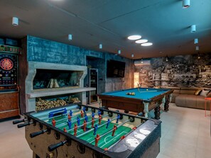 A room with a foosball table, a pool table, a dartboard, and a fireplace. - 5-bedroom Estate With Heated Pool (Kastela)