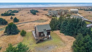 A coastal property with a large house, a smaller cabin, and a beach view. - Family-Friendly, Waterfront Home with Free WiFi, Gas Fireplace, & Private W/D (Long Beach)