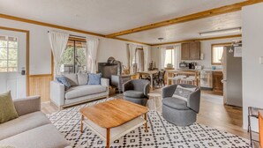 A spacious living area with a sofa, armchairs, and a coffee table. - Recently updated in 2024-Large, dog-friendly home with covered deck (Government Camp)