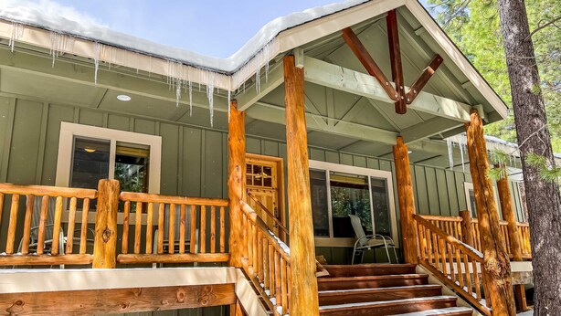 A wooden deck with a staircase leading to a covered porch. - Dog-Friendly Sunriver Home with Fireplace, Deck & Central AC (Sunriver)