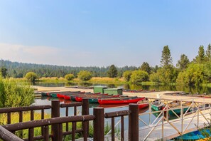 A lakeside dock with canoes and a wooden walkway. - Multi-level home with private hot tub, decks, and SHARC passes provided (Sunriver)