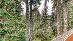 A forested area with tall trees and a wooden structure. - Mountain-view house near skiing with a great kitchen & private hot tub (Government Camp)