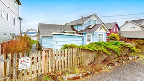 A residential area with houses, a wooden fence, and a rental sign.