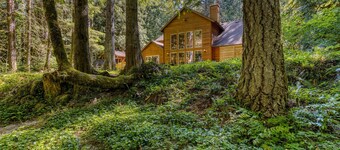 Classic riverfront home with great views, game room, hot tub, & modern cabin feel