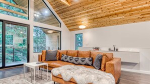 A modern interior with a leather sofa, a fur throw, and a small white table.