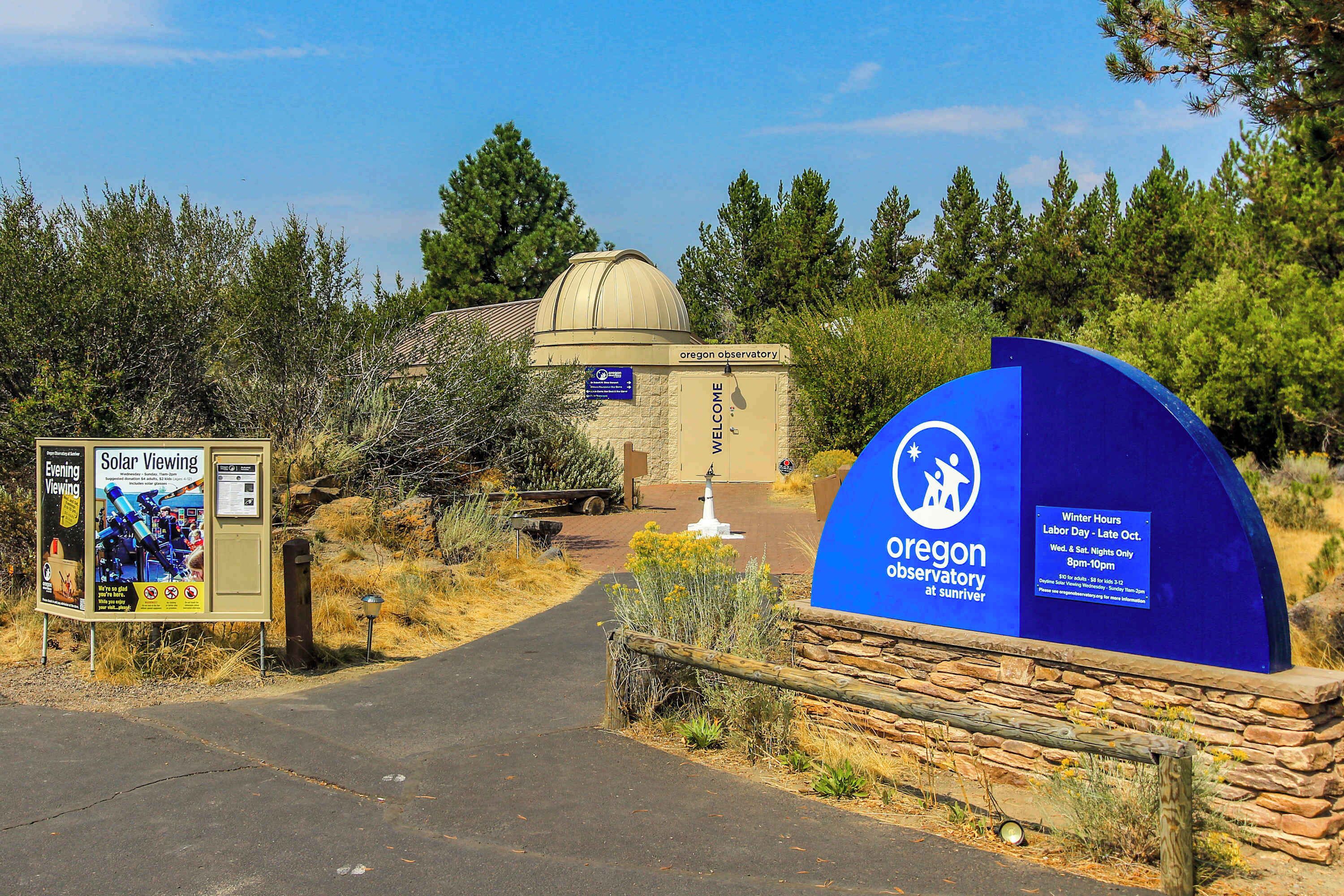 The entrance to the Oregon Observatory at Sunriver with a sign indicating solar viewing and winter hours.