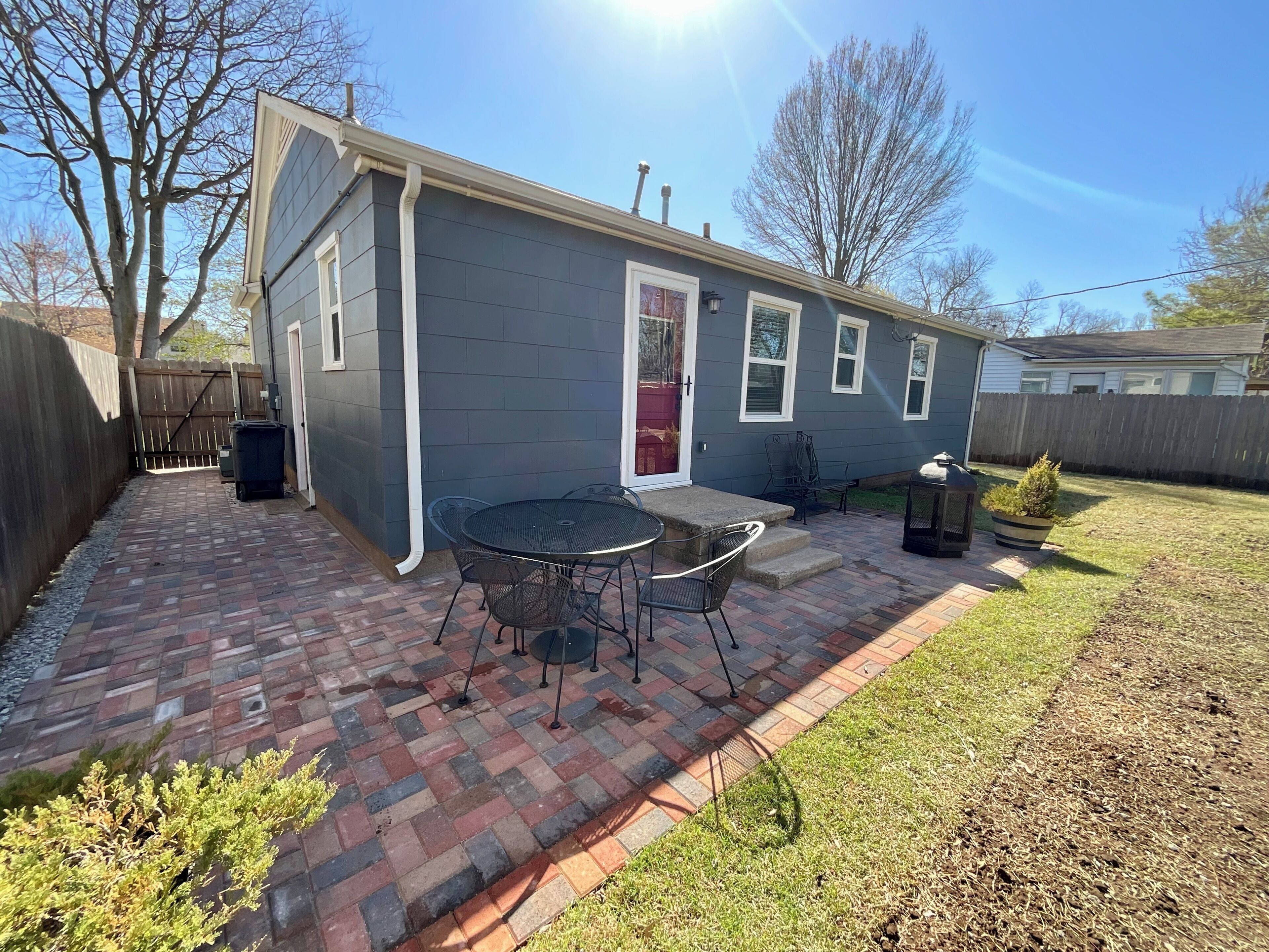 A residential house with a patio, a door, and a small garden area.