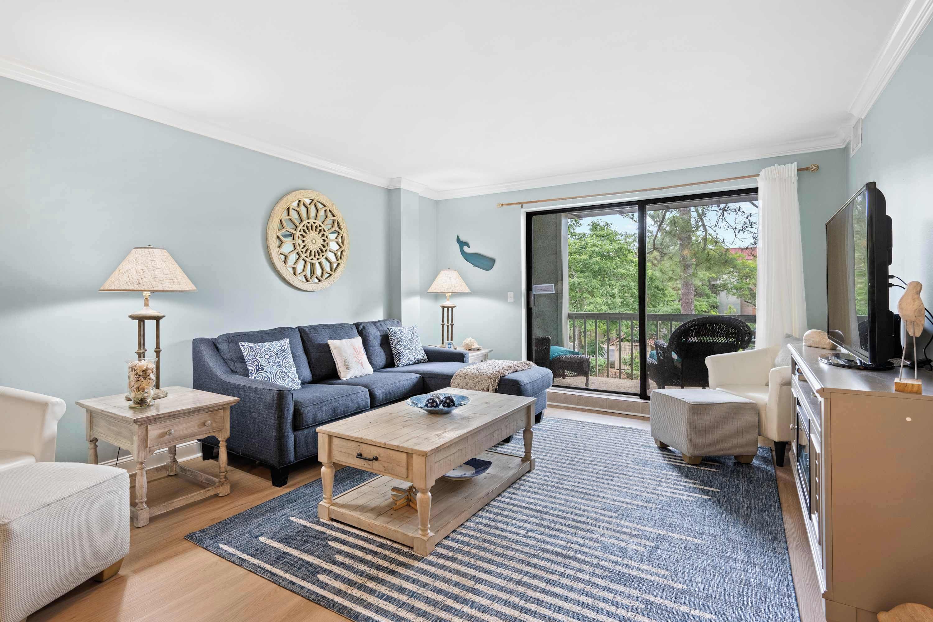 A living room with a sofa, coffee table, and TV stand.