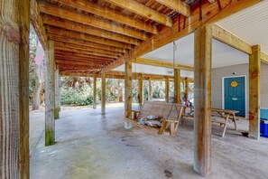 An open wooden structure with a swing, a picnic table, and a door marked 'ADS'. - Just Trippin' (Edisto Beach)
