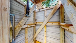 A wooden interior with a metal staircase and a window. - Beautiful home within walking distance to the Beach w/ Free WiFi, Sun Deck (Edisto Beach)