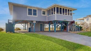 A two-story house with a covered porch and a small deck. - Beachfront home w/ Patio, Private W/D, & Free WiFi (Edisto Beach)