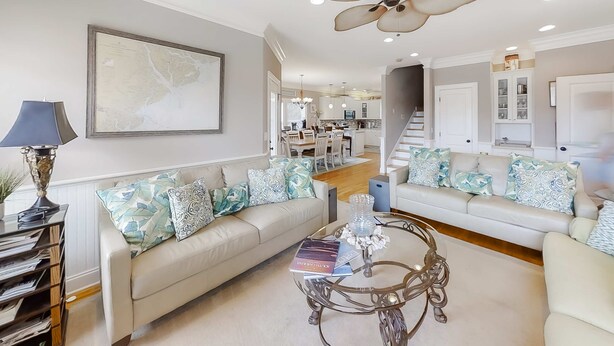 A living room with a sofa, coffee table, and a ceiling fan. - Fantastic House 2 Blocks From Beach w/Private Pool, Free WiFi, Central AC, & W/D (Edisto Beach)