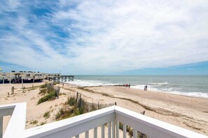 A beach with a wooden pier, sandy beach, and ocean view. - Newly renovated beachfront house w/Patio, Free WiFi, Private W/D, AC (Edisto Beach)