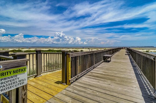 Waterfront villa with resort amenities, beach access, open layout, AC, & W/D