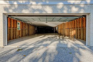A covered garage with a concrete floor and wooden walls. - North Forest Beach home with a private pool and four primary suites (Hilton Head)