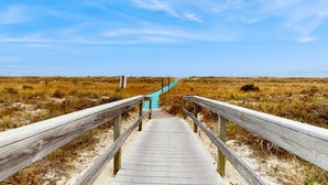 A wooden boardwalk leading to a staircase in a natural landscape. - Oceanfront villa with WiFi, full kitchen, pool, & hot tub - beach nearby (Hilton Head)